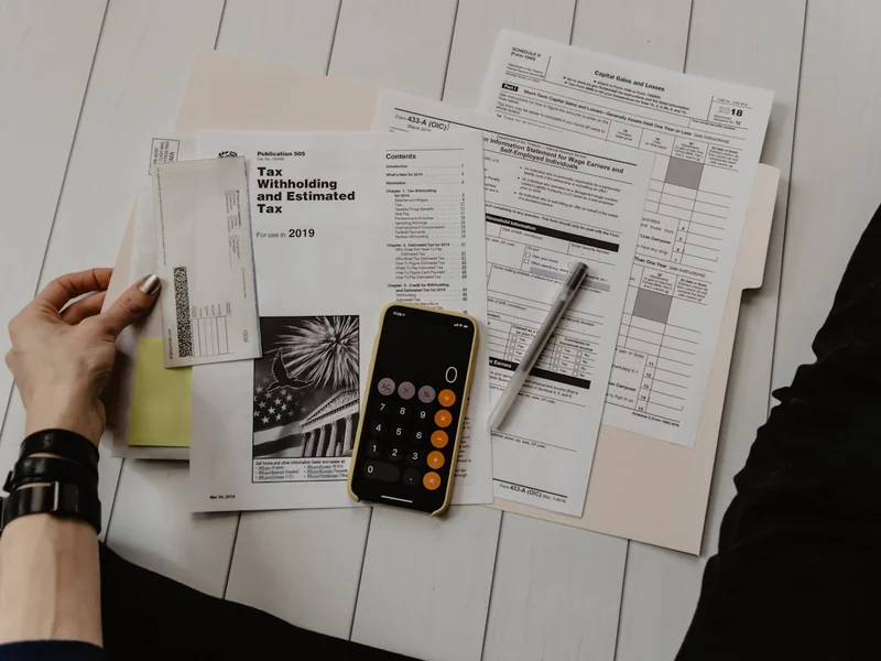Bookkeeper working on accounts with spreadsheets and receipts