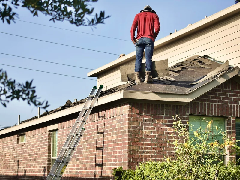 Roofer working on a house roof
